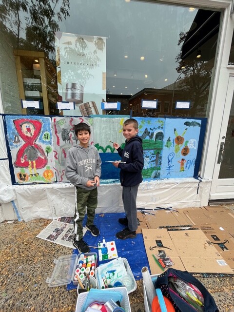 (PHOTO: Midland School’s Owen Picker and Zachary Stewart Lewis add to an already colorful window at Blue Mercury.)