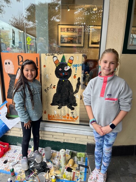 (PHOTO: Osborn School students, Isabella Koh and Amarinta Boxford, put the finishing touches on their window at Starbucks.)