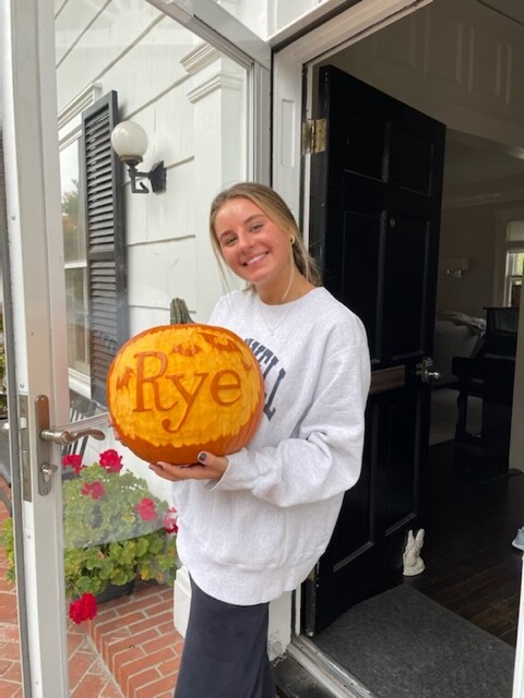 (PHOTO: Rye High School Sophomore Chole McComb won one of several professionally-carved pumpkins for her doorstep.)