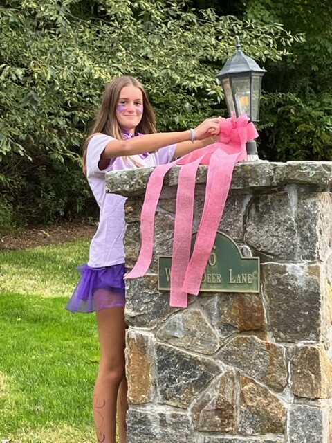 (PHOTO: Bridget Kelly tying the town pink on Saturday for TieTheTownPink. Photo credit: Elissa Kelly.)