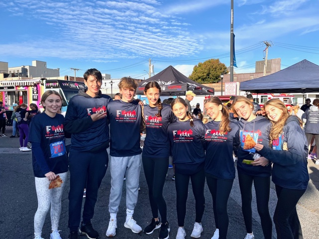 (PHOTO: Rye High School, Greenwich Country Day and Rye Country Day students enjoy breakfast pizza and early morning Bona Bona ice cream after their run.)