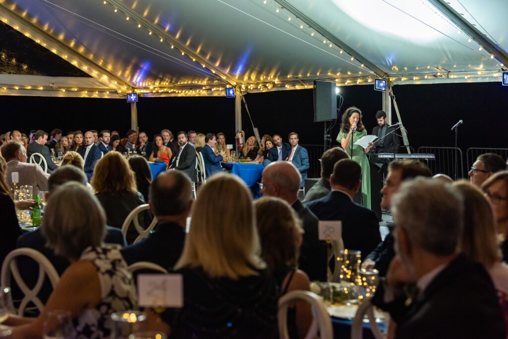 (PHOTO: Nonie Reich, daughter of Deedee Paschal, one of the five founders of the Jay Heritage Center, addresses the crowd at the 30th Anniversary Moonlight Soirée on September 17, 2022.)