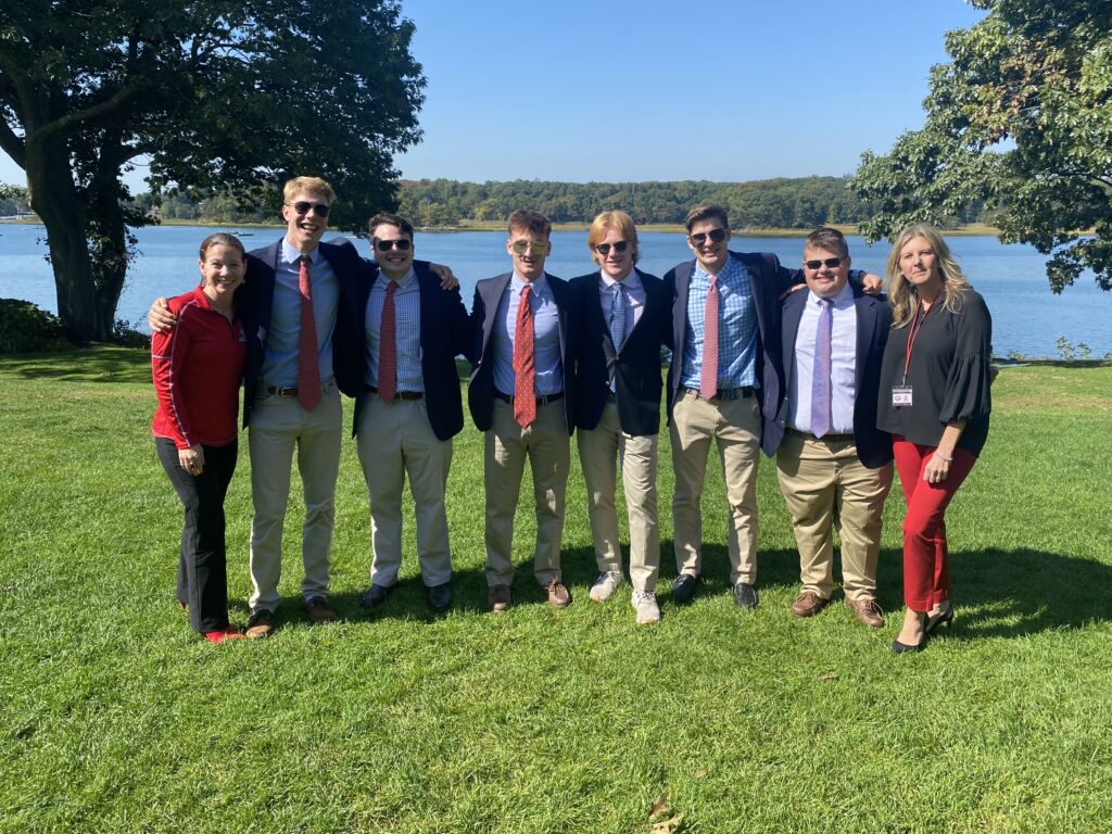 (PHOTO: Rye Varsity Football Captains AJ Miller, Owen Meyers, Jack Mullooly, Christopher Guazzo, Luke Iuliano, and Bobby Townsend at the Rye Rotary Annual Sportsmanship Luncheon at the Wainwright House on Friday, October 7, 2022. The Captains are bookended by Rye High School Principal Suzanne Short on the left and Rye Athletic Director Susan Reid Dullea on the right.)