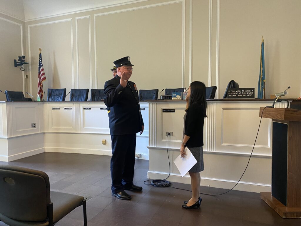 (PHOTO: Rye FD Lieutenant John Thompson is sworn in by Deputy City Clerk Euka Pietrosanti at his swearing in at Rye City Hall on October 18, 2022.)