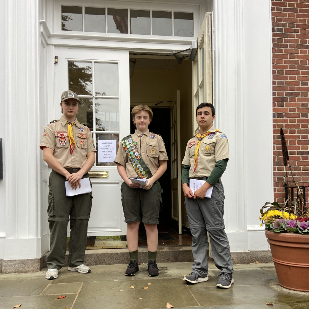 (PHOTO: Rye Troop 2 scouts distributed programs at the Veterans Day ceremony Friday. Left to right: Logan Jancski, Aiden Harvey and Max Cea.)