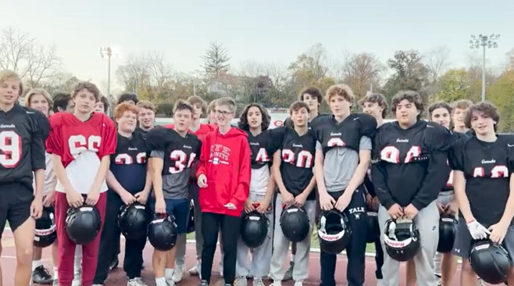 (PHOTO: Garnet football players with #46 TJ Neeves.)