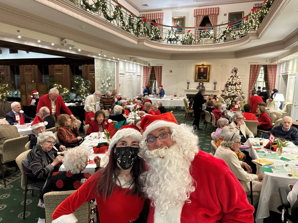 (PHOTO: A very familiar Santa came early to The Osborn on Wednesday night, December 14, 2022. Santa and his jolly old elf came bearing gifts of candy for residents of The Osborn’s Sterling Park Independent Living community at its annual Holiday Party.)