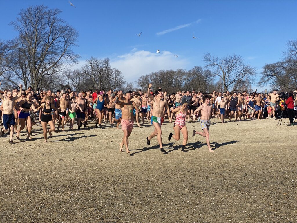 (PHOTO: The 21st Annual Polar Bear Plunge was held on January 1st, 2023 in Rye Town Park and honored Norbert Galligan.)