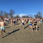 (PHOTO: The 21st Annual Polar Bear Plunge was held on January 1st, 2023 in Rye Town Park and honored Norbert Galligan.)