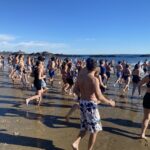 (PHOTO: The 21st Annual Polar Bear Plunge was held on January 1st, 2023 in Rye Town Park and honored Norbert Galligan.)