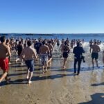 (PHOTO: The 21st Annual Polar Bear Plunge was held on January 1st, 2023 in Rye Town Park and honored Norbert Galligan.)