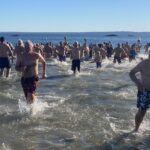 (PHOTO: The 21st Annual Polar Bear Plunge was held on January 1st, 2023 in Rye Town Park and honored Norbert Galligan.)