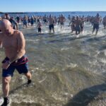 (PHOTO: The 21st Annual Polar Bear Plunge was held on January 1st, 2023 in Rye Town Park and honored Norbert Galligan.)