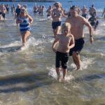 (PHOTO: The 21st Annual Polar Bear Plunge was held on January 1st, 2023 in Rye Town Park and honored Norbert Galligan.)