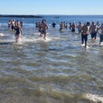 (PHOTO: The 21st Annual Polar Bear Plunge was held on January 1st, 2023 in Rye Town Park and honored Norbert Galligan.)