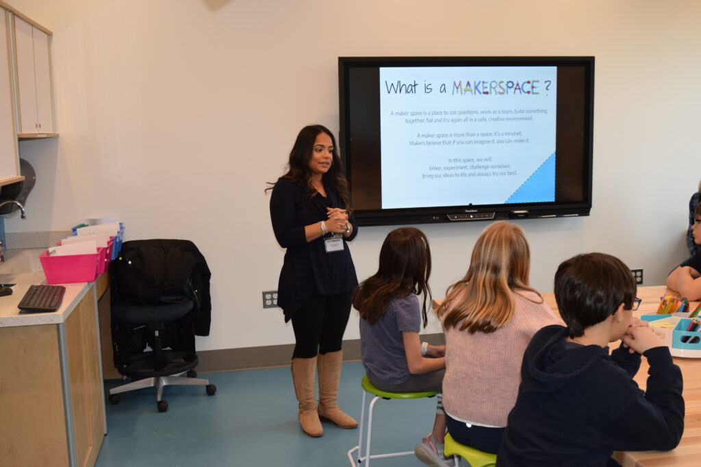 (PHOTO: Rye City School District Instructional Coach Kim Persaud introduces Midland students to makerspace.)