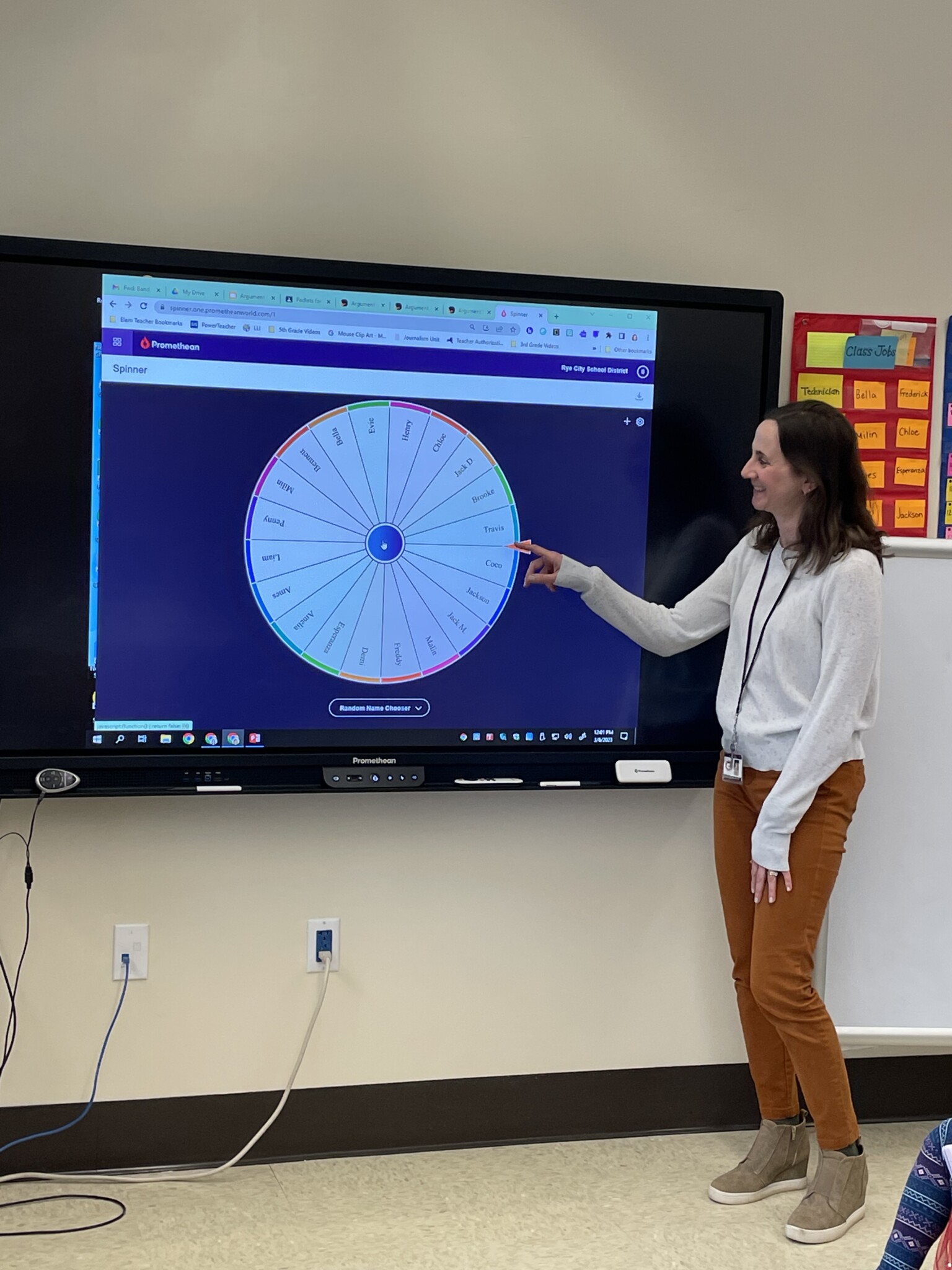 (PHOTO: Osborn Elementary School 5th grade teacher Katy Buderman delivers to goods on the new Promethean display boards.)