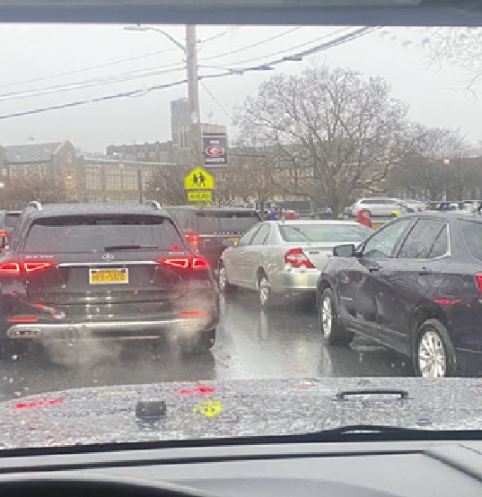 (PHOTO: Cars, sitting in traffic, idling at Rye High School.)