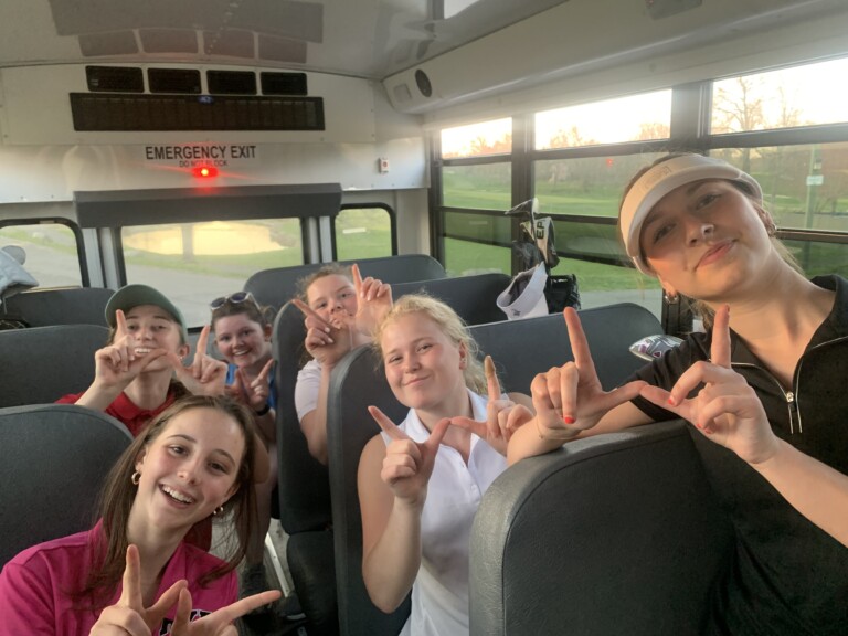 (PHOTO: The 2023 Rye Girls Varsity Golf team on the bus.)