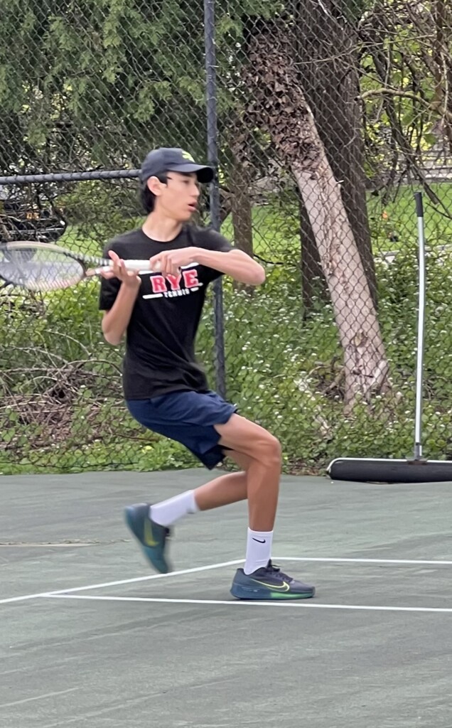 (PHOTO: Rye Boys Varsity Tennis player Lou Kim-Reuter playing 4th singles on Friday versus Fox Lane with a great comeback and a "W!".)