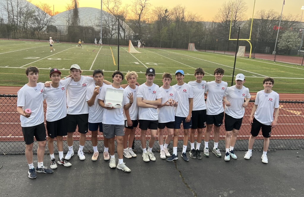 (PHOTO: The 2023 Rye Boys Varsity Tennis confident and happy with some donuts on Wednesday.)