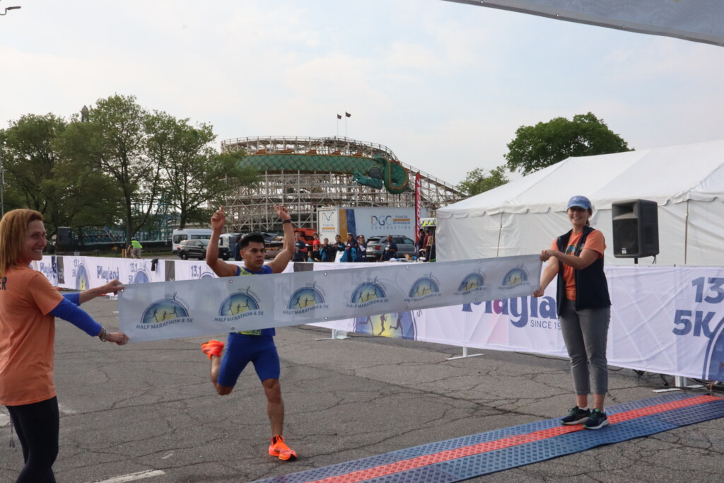 (PHOTO: Soul Ryeders inaugural half marathon and 5K run was held on Sunday, May 21, 2023. 5k male winner Avi Portillo (17:12 run time) at the finish line. Credit: Sierra Desai.)