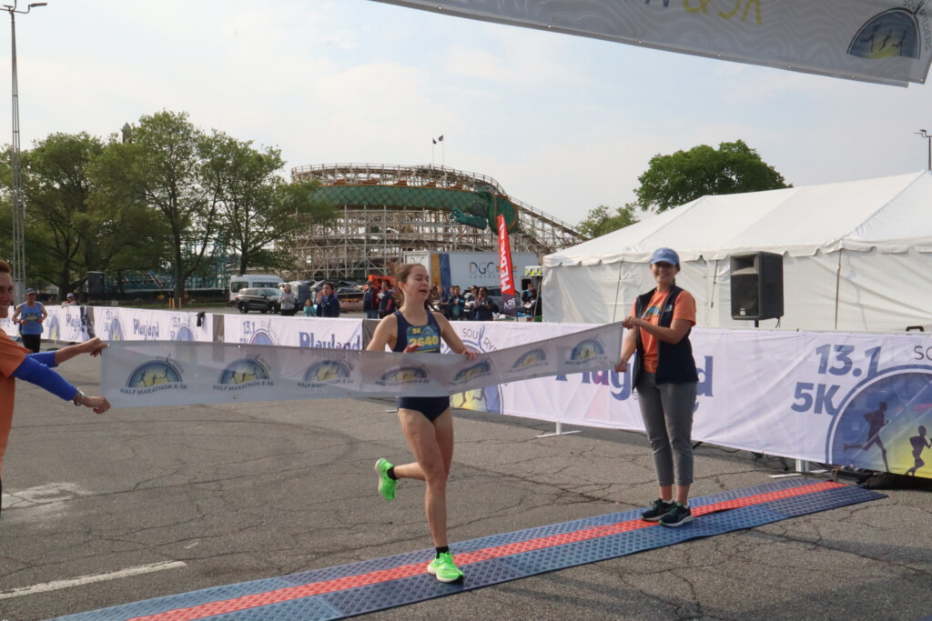 (PHOTO: Soul Ryeders inaugural half marathon and 5K run was held on Sunday, May 21, 2023. 5K female winner Erica Wood (18:28 run time) at the finish line. Credit: Sierra Desai.)