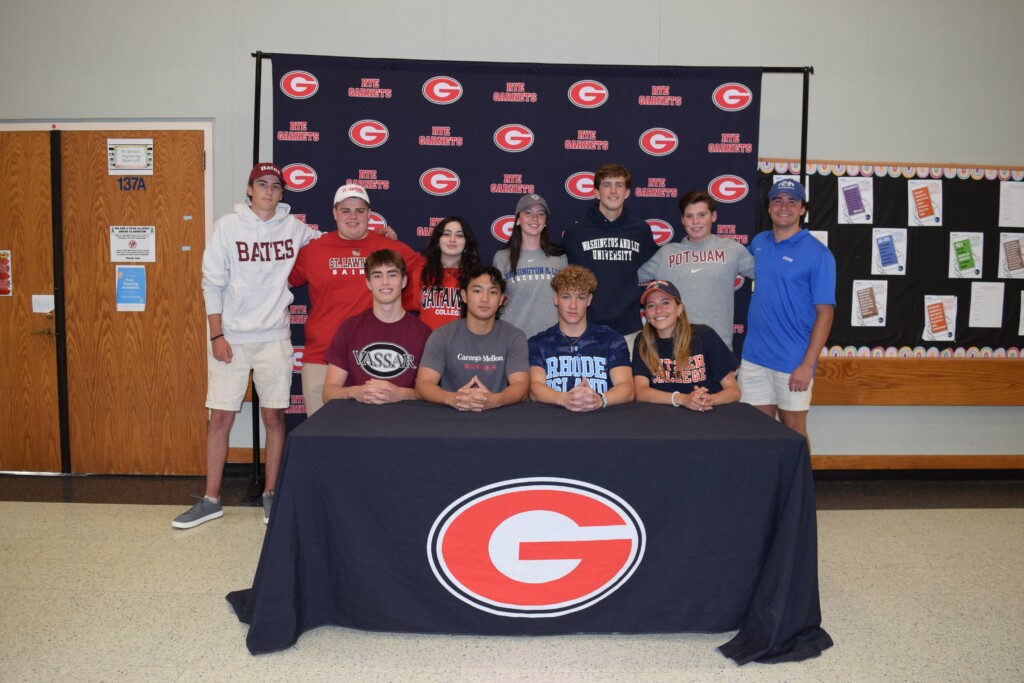 (PHOTO: Rye High School held its NLI (National Letter of Intent) signing ceremony on Wednesday, May 24, 2023. Thirteen students have committed to their colleges and athletic programs. Front row, left to right: Sebastian Medina, Ryoya Koide, Stijn Terlouw, Maren Wydra. Back row, left to right: Charlie Weinman, Bobby Townsend, Natalie Jackson, Ella Buckley, Andrew Keller, Patrick Quinn, Will Bainbridge.)