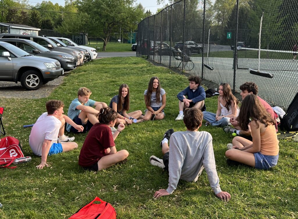 (PHOTO: Rye Boys Varsity Tennis circle time with the fans after the match versus Scarsdale B on Wednesday.) 