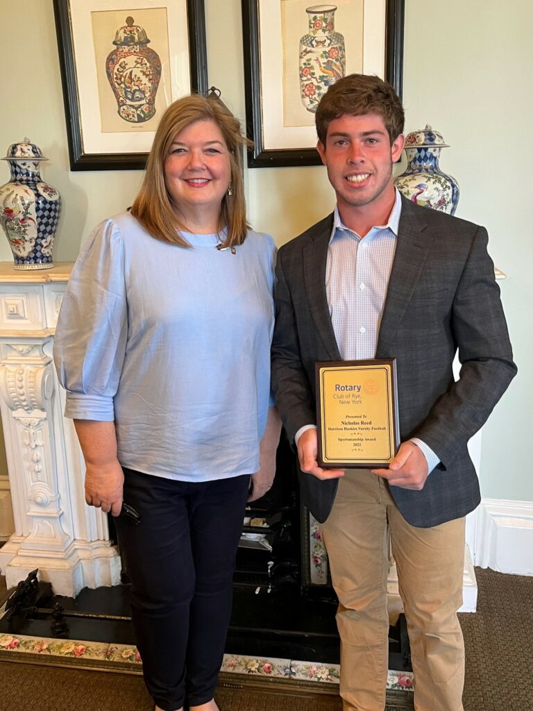 (PHOTO: Harrison Varsity Football player Nicholas Reed with Rye Rotary President Michele Thomas at the Rye Rotary sportsman's lunch on April 21, 2023.)