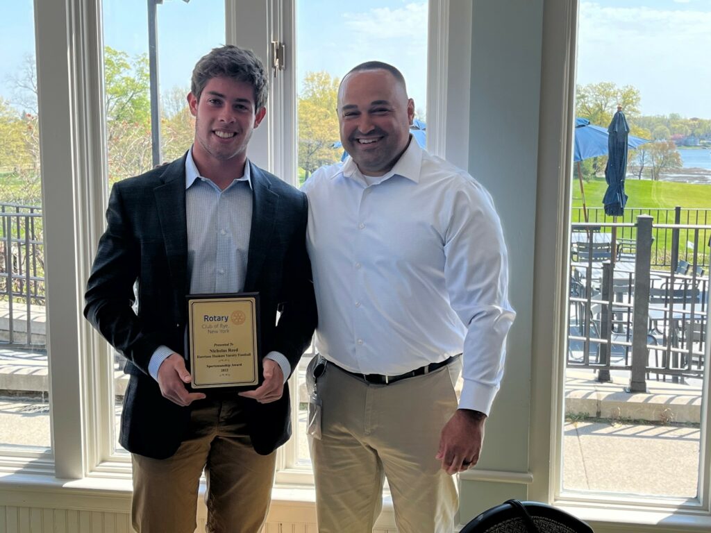 (PHOTO: Harrison Varsity Football player Nicholas Reed with Harrison Football Coach Jay Ciraco at the Rye Rotary sportsman's lunch on April 21, 2023.)