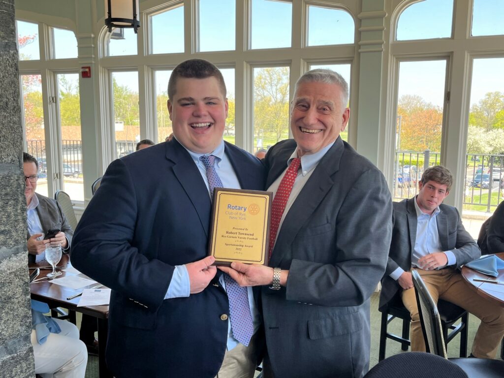 (PHOTO: Rye Varsity Football player Robert Townsend with Rye Football Coach Dino Garr at the Rye Rotary sportsman's lunch on April 21, 2023.)