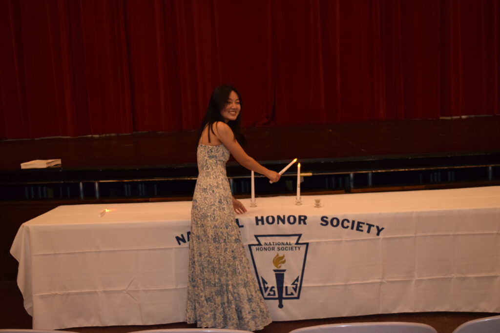 (PHOTO: For the National Honor Society (NHS) ceremony, Sofie Fu lit the Candle of Service.)