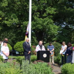 (PHOTO: Pastor Jim O’Hanlan from St. Paul’s Lutheran church shares a few words at the Pride flag raising in Rye Town Park on Saturday, June 10, 2023. Credit: Sierra Desai.)