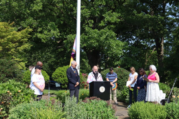 (PHOTO: Pastor Jim O’Hanlan from St. Paul’s Lutheran church shares a few words at the Pride flag raising in Rye Town Park on Saturday, June 10, 2023. Credit: Sierra Desai.)