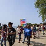 (PHOTO: Community members and supporters parade through Rye Town Park on Saturday, June 10, 2023. Credit: Sierra Desai.)