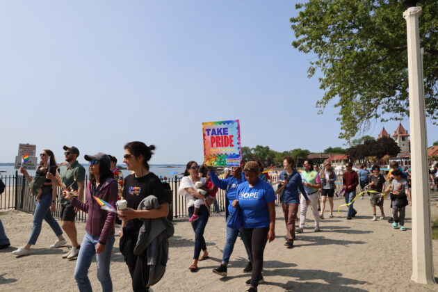 (PHOTO: Community members and supporters parade through Rye Town Park on Saturday, June 10, 2023. Credit: Sierra Desai.)