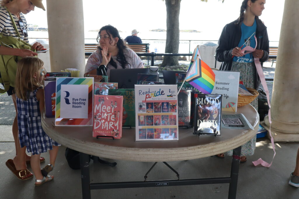 (PHOTO: The Rye Free Reading Room was one of two libraries at the Pride fair in Rye Town Park on Saturday, June 10, 2023. Credit: Sierra Desai.)