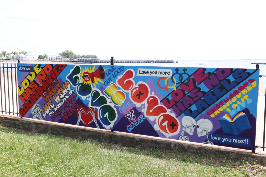 (PHOTO: The 2023 pRYEde mural, finally unveiled in Rye Town Park on Saturday, June 10, 2023. Credit: Sierra Desai.)