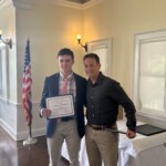 (PHOTO: Tommy Broderick receives a student-athlete of the month certificate from Varsity Boys' Soccer Coach Jared Small.)