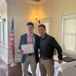 (PHOTO: Tommy Broderick receives a student-athlete of the month certificate from Varsity Boys' Soccer Coach Jared Small.)