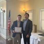 (PHOTO: Dempsey Brown receives a student-athlete of the month certificate from Varsity Ice Hockey coach Peter Thomas.)