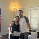 (PHOTO: Cate Doyle receives a student-athlete of the month certificate from Varsity Track & Field coach Kevin Murphy.)