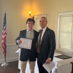 (PHOTO: Dan Dalton receives a student-athlete of the month certificate from Varsity Rugby coach Jim O'Hara.)
