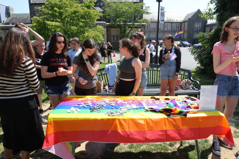 (PHOTO: The GSA club’s booth with Pride goodies being handed out to students in front of the high school. Credit: Sierra Desai.)