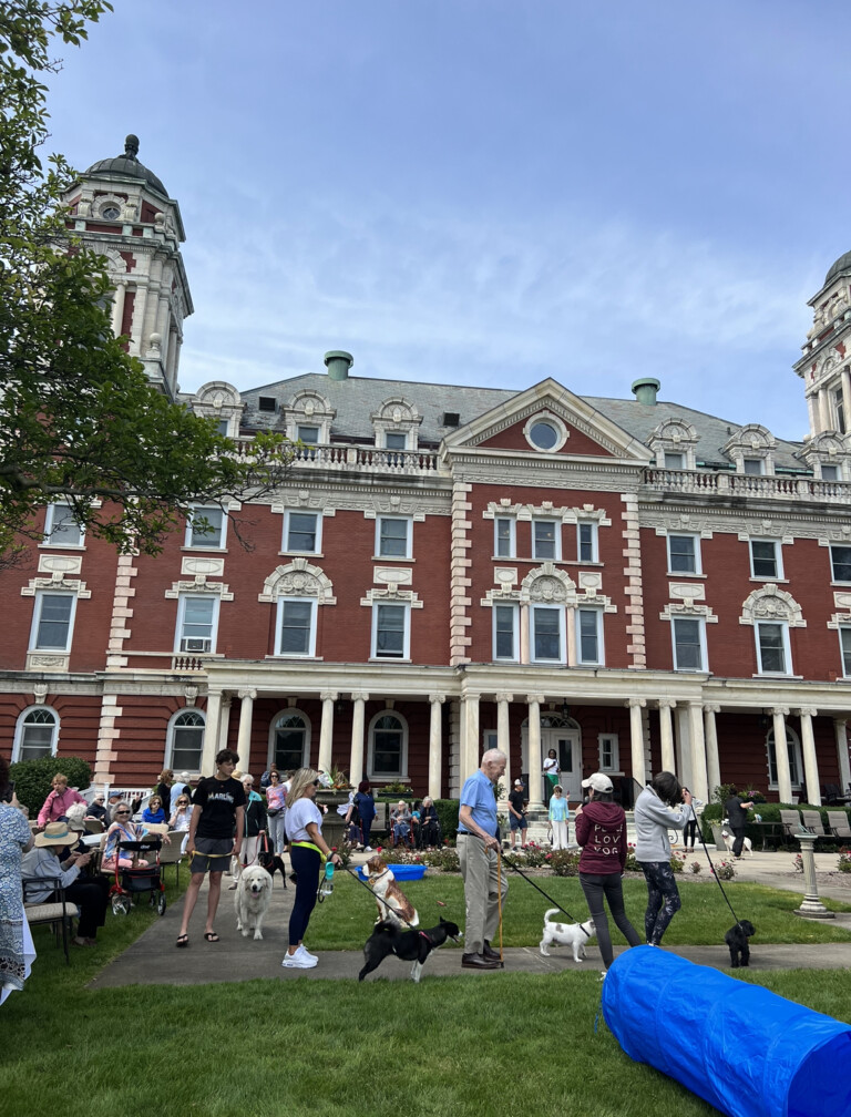 Osborn residents, staff, and guests introducing their dogs to the crowd at the start of the Dog Days of Summer event.