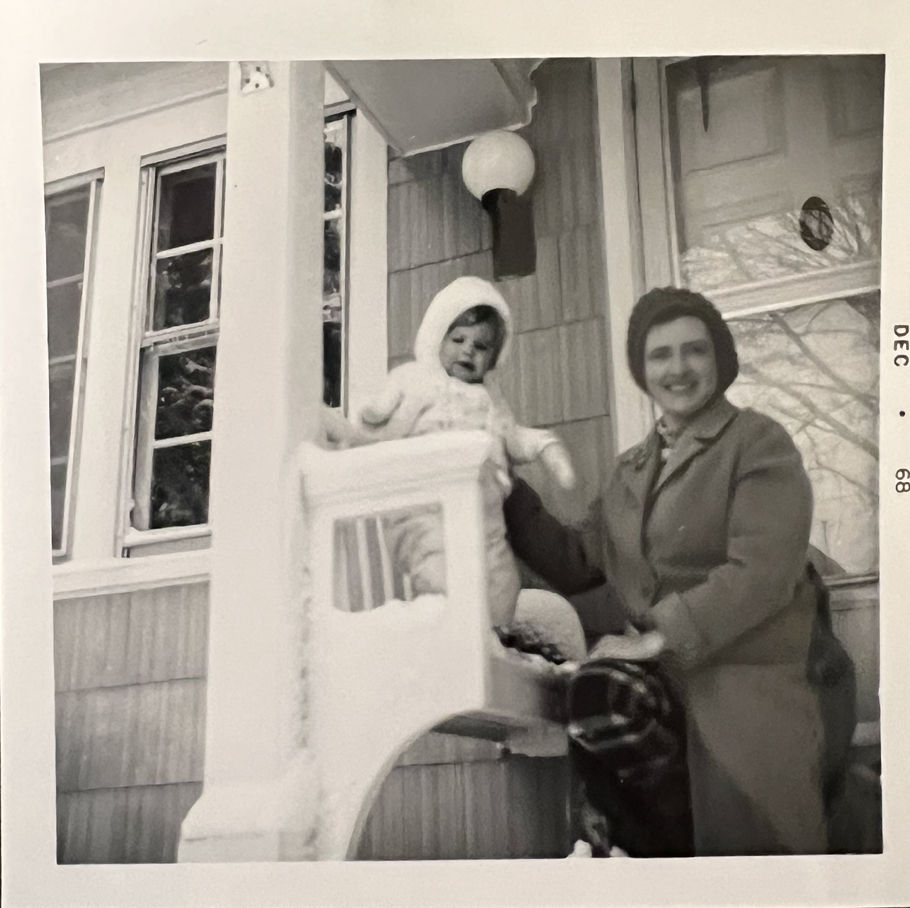 (PHOTO: Sally Lee sitting with her daughter, Dorothy Lee, on their Mead Place house steps in December 1968.)
