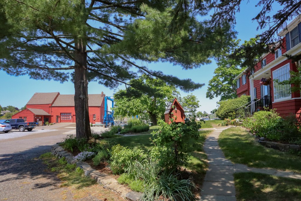 (PHOTO: The iconic red Tide Mill house (on the left), part of the Tide Mill Yacht basin. Credit: Sierra Desai.)