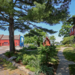 (PHOTO: The iconic red Tide Mill house (on the left), part of the Tide Mill Yacht basin. Credit: Sierra Desai.)