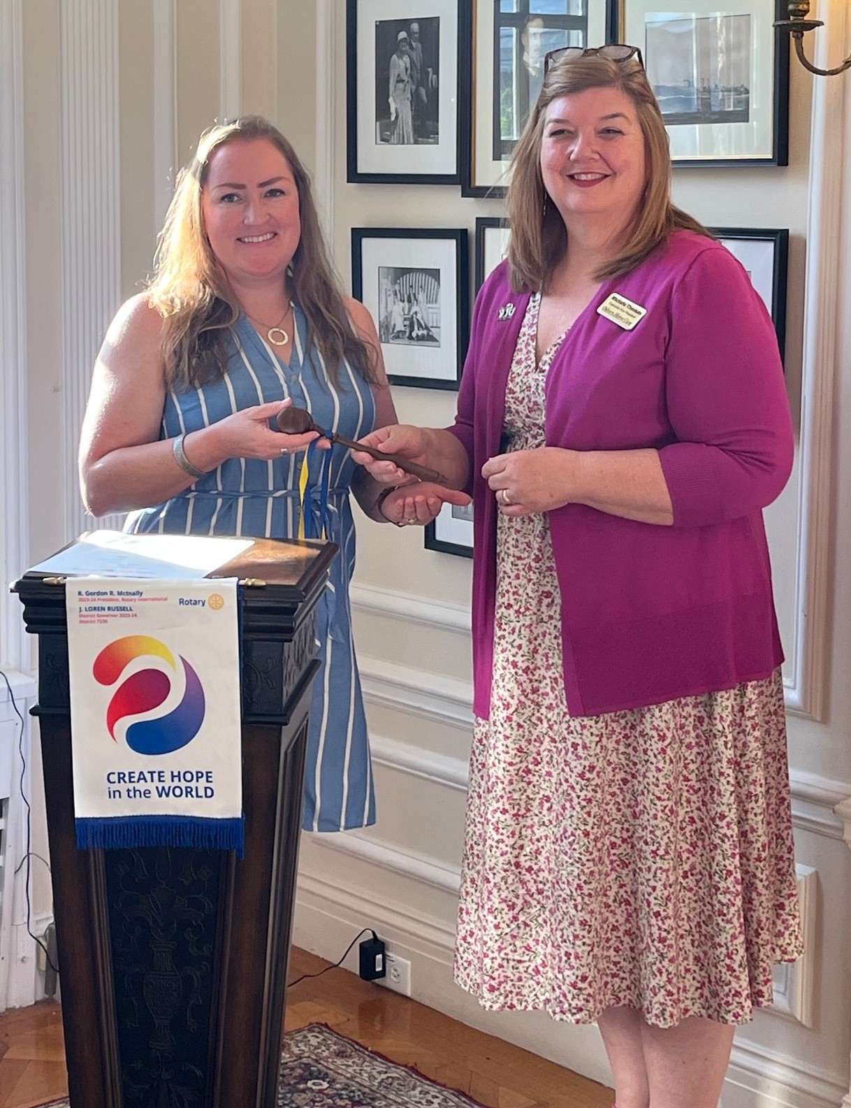 (PHOTO: Michele Thomas, EVP of Osborn Home Care (Immediate past president) handing the gavel over to Lauren Torres, Private Banking Offices Manager at JP Morgan Chase Bank as the new president for the 23/24 term during the induction ceremony at Wainwright House)